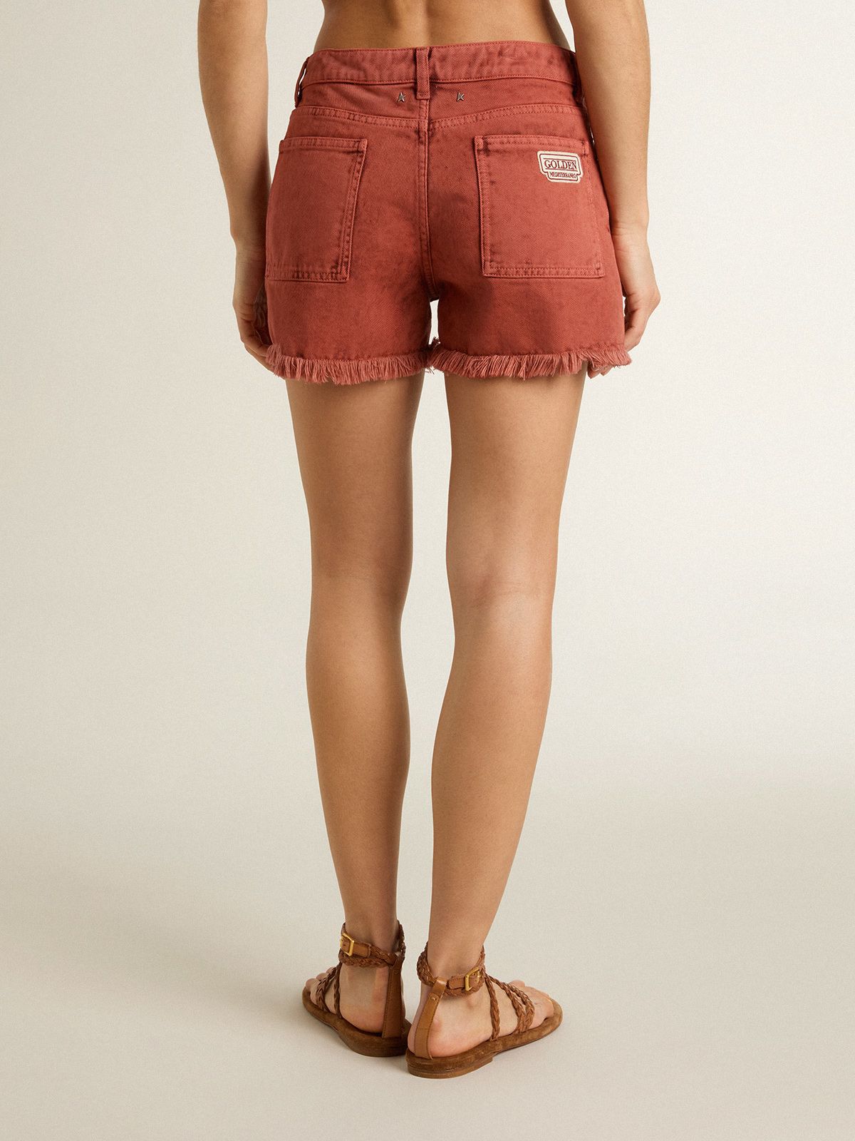Women's shorts in brick-red denim with Golden Mediterraneo embroidery