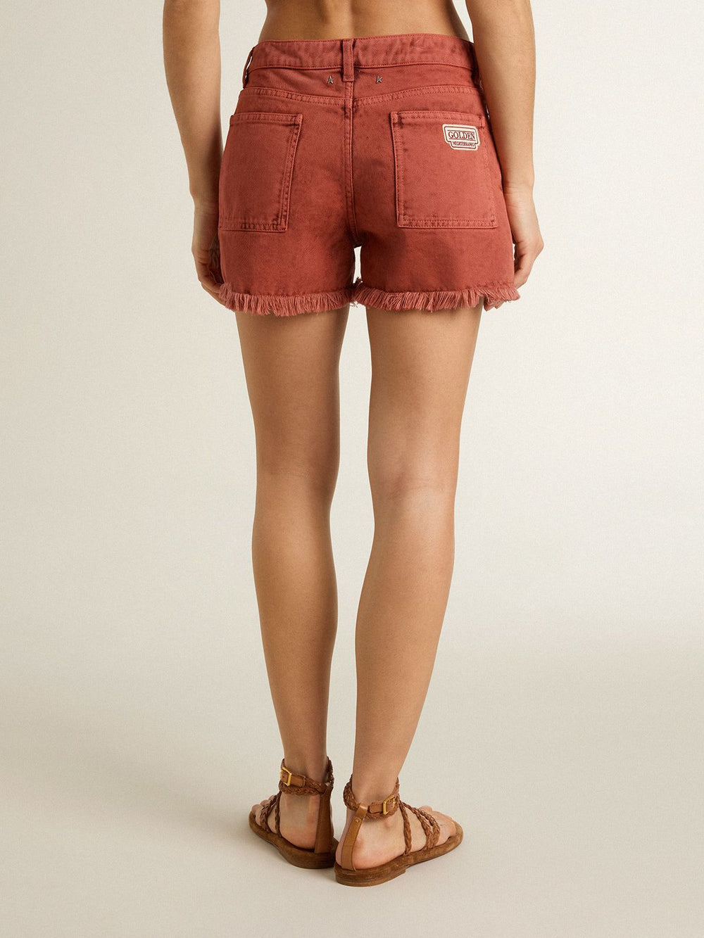 Women's shorts in brick-red denim with Golden Mediterraneo embroidery