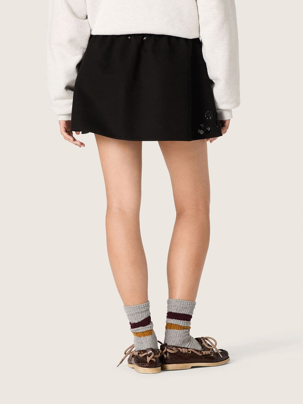 Women’s miniskirt in black cotton twill with floral sequin embroidery