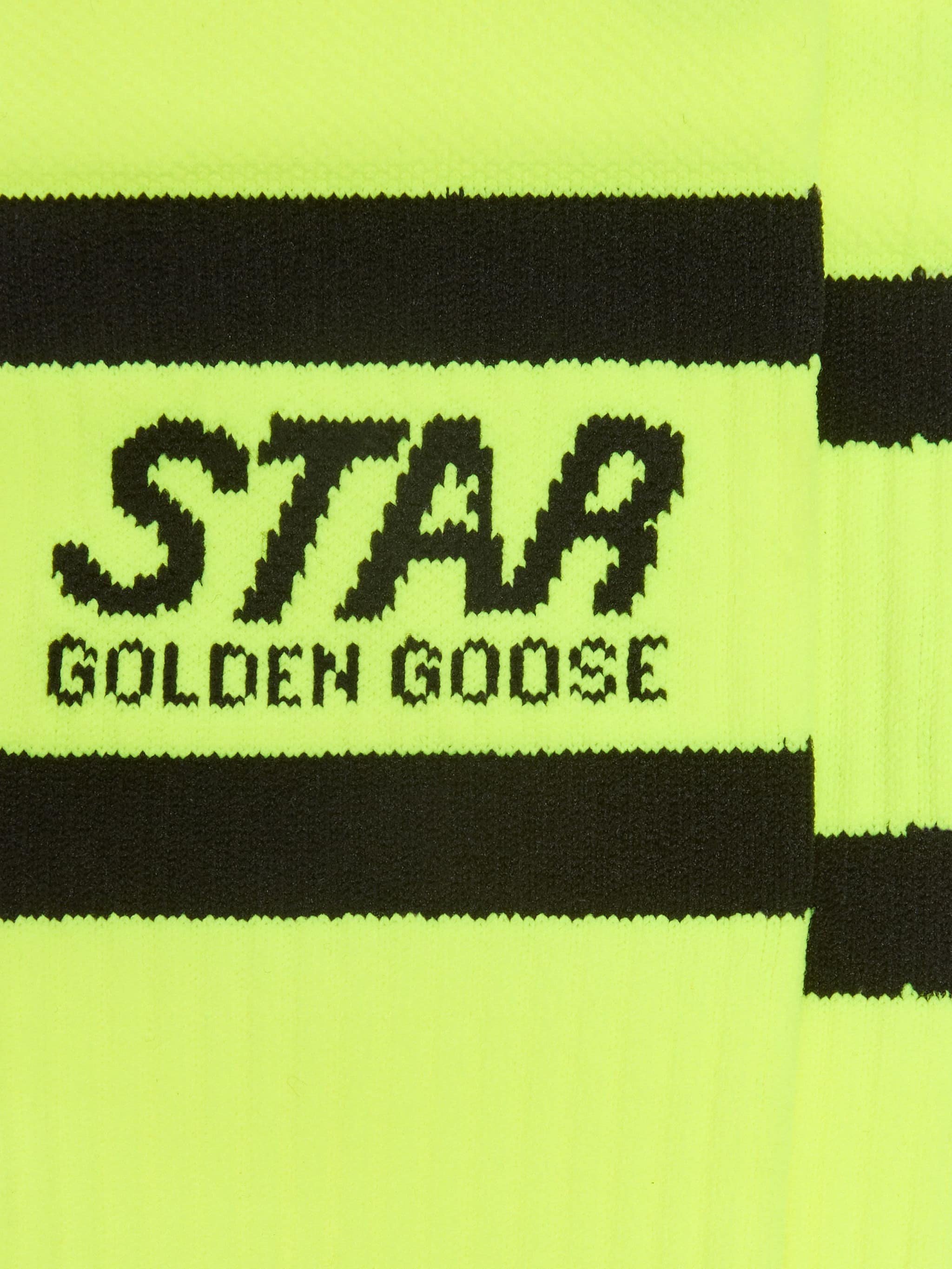 Neon yellow sports socks with black stripes