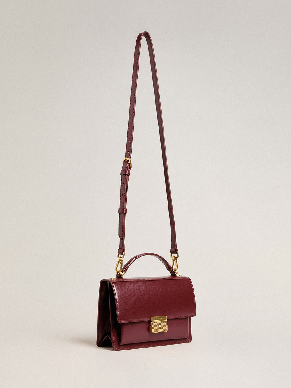Venezia Bag in burgundy boarded leather with gold details