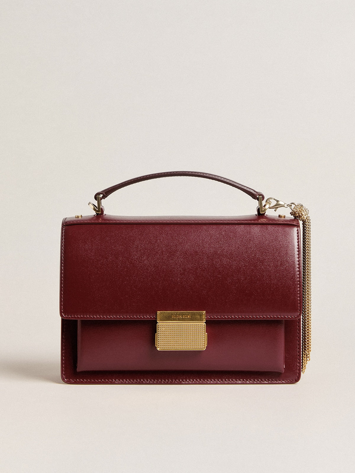 Venezia Bag in burgundy boarded leather with gold details