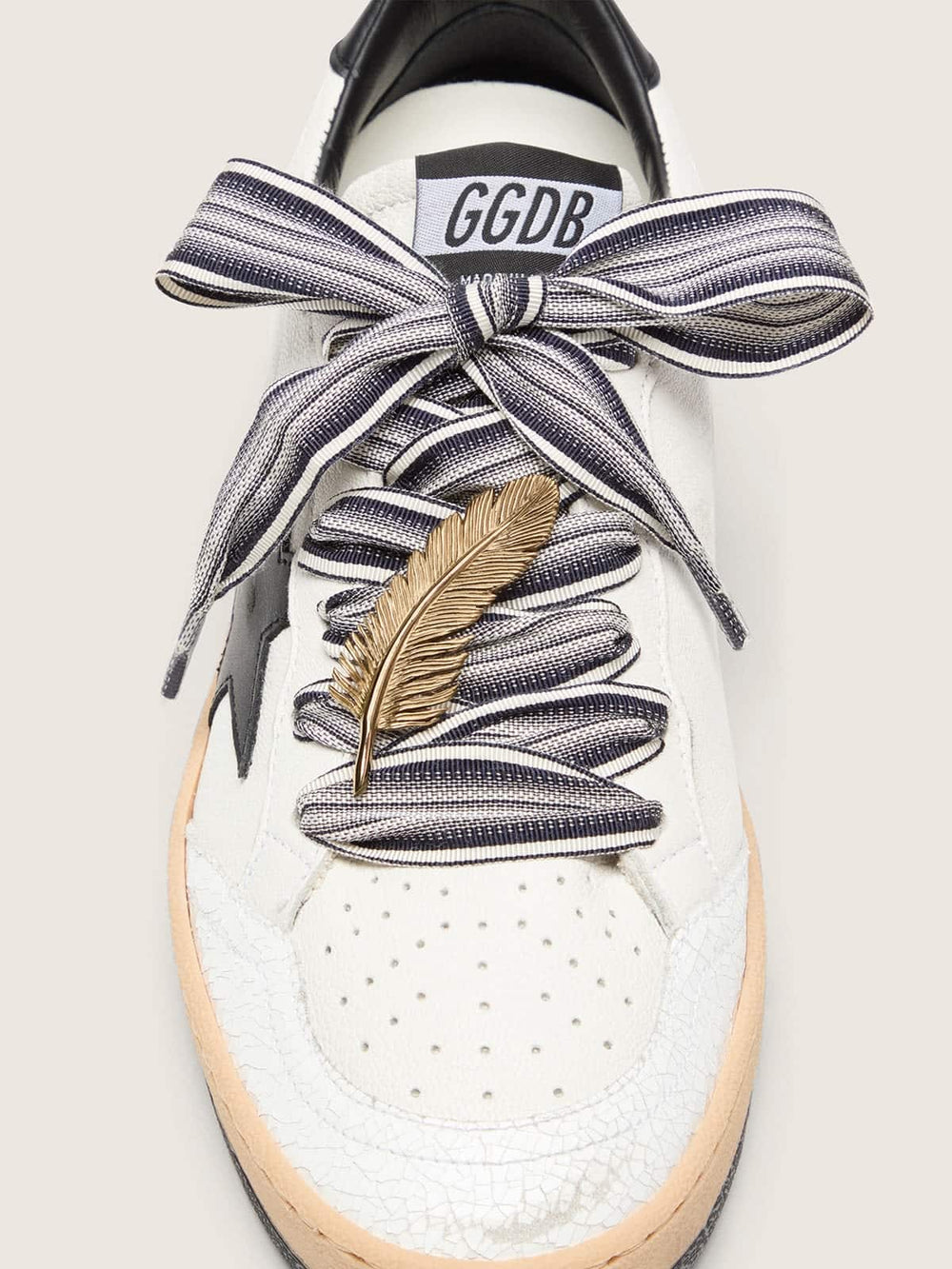 Skins striped laces with gold feather charm