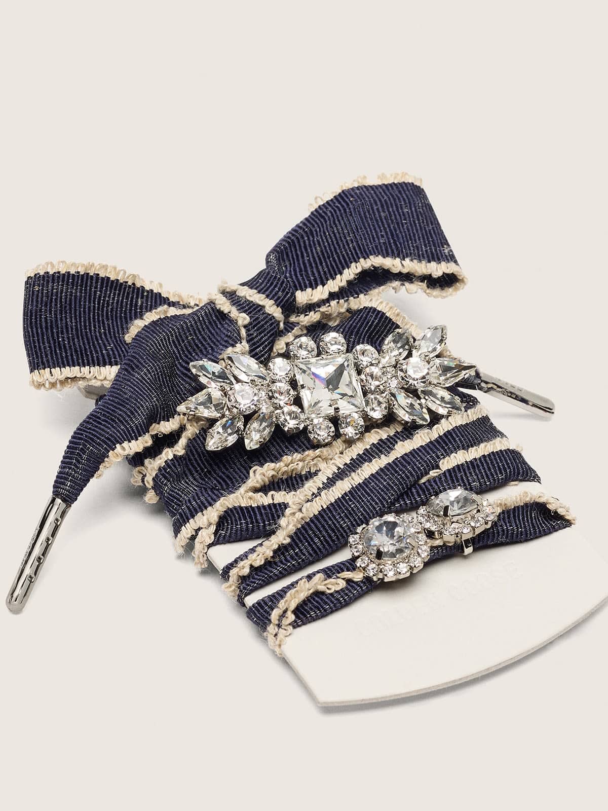 Skins denim blue laces embellished with beige trim and two charms