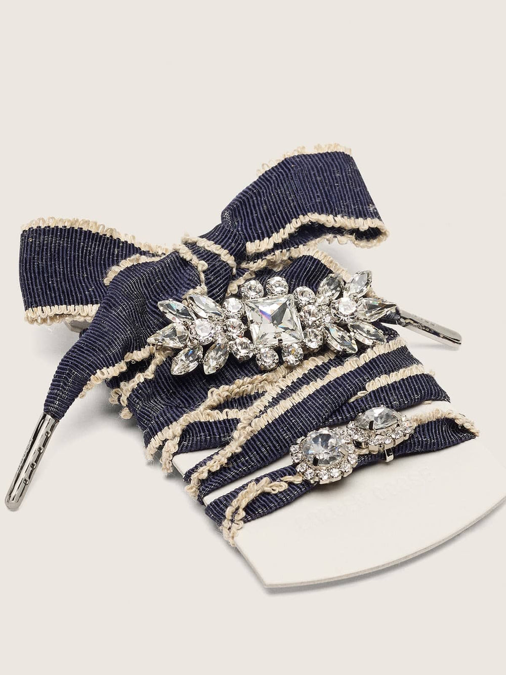 Skins denim blue laces embellished with beige trim and two charms