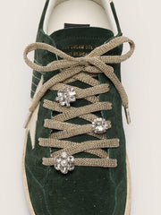 Skins braided gold-colored laces with shimmering charms