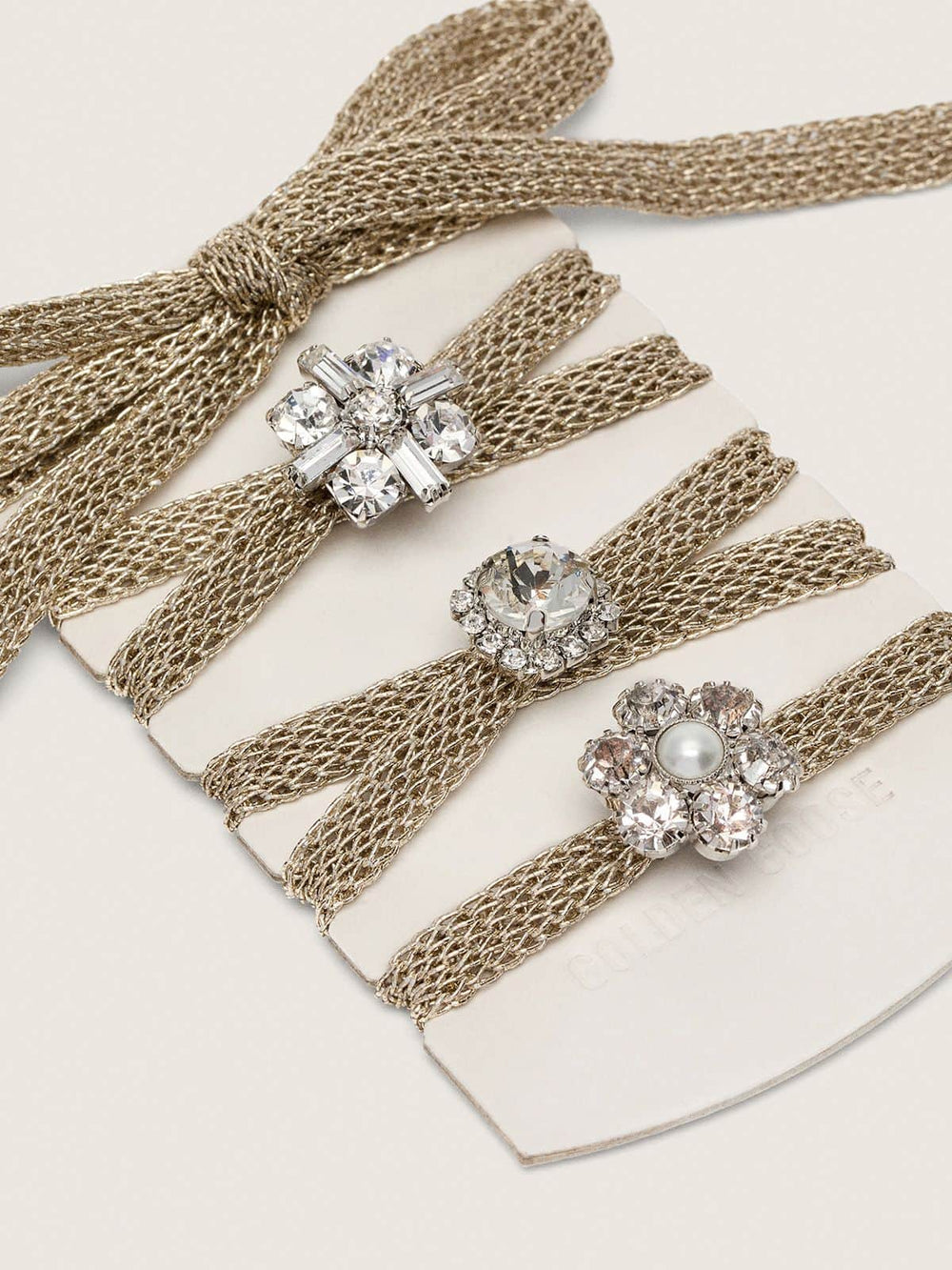 Skins braided gold-colored laces with shimmering charms