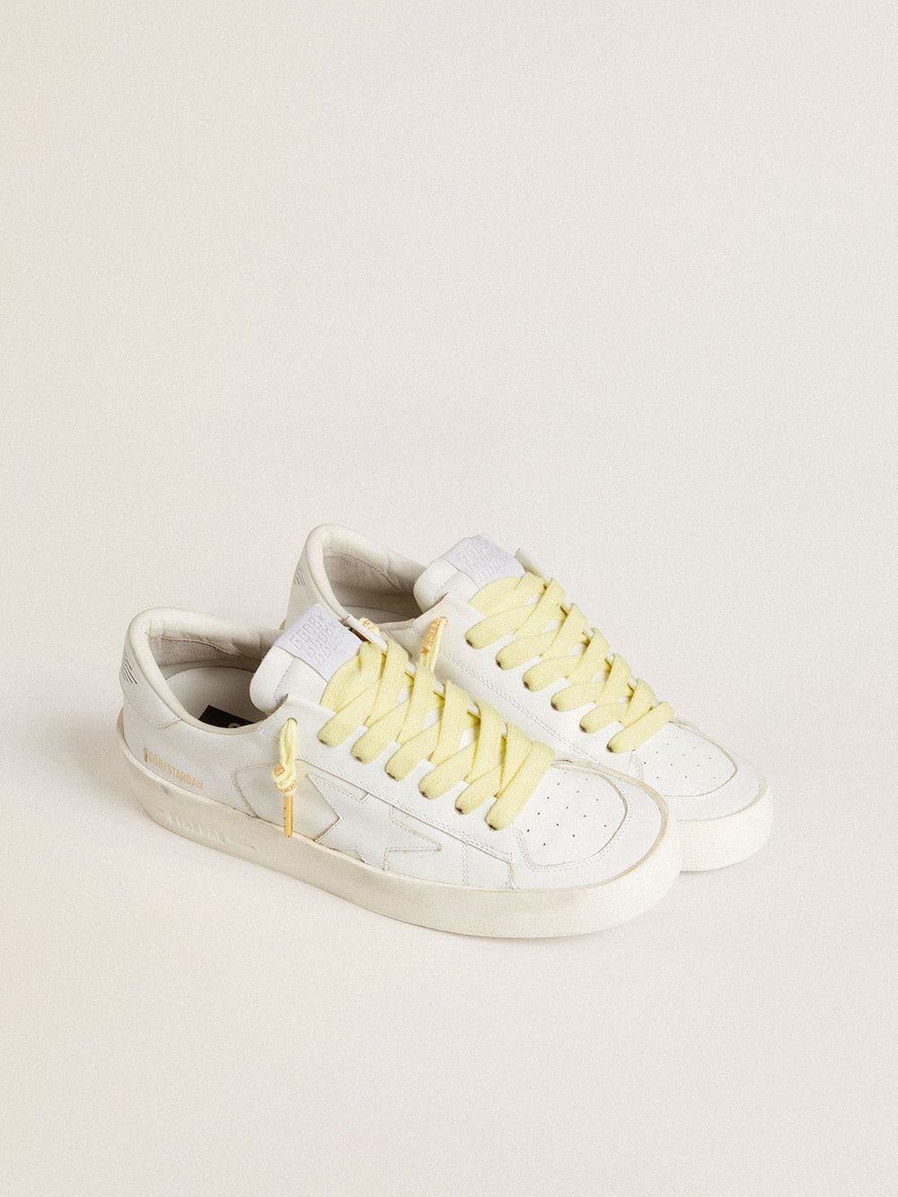 Yellow cotton laces with contrasting gold-colored logo