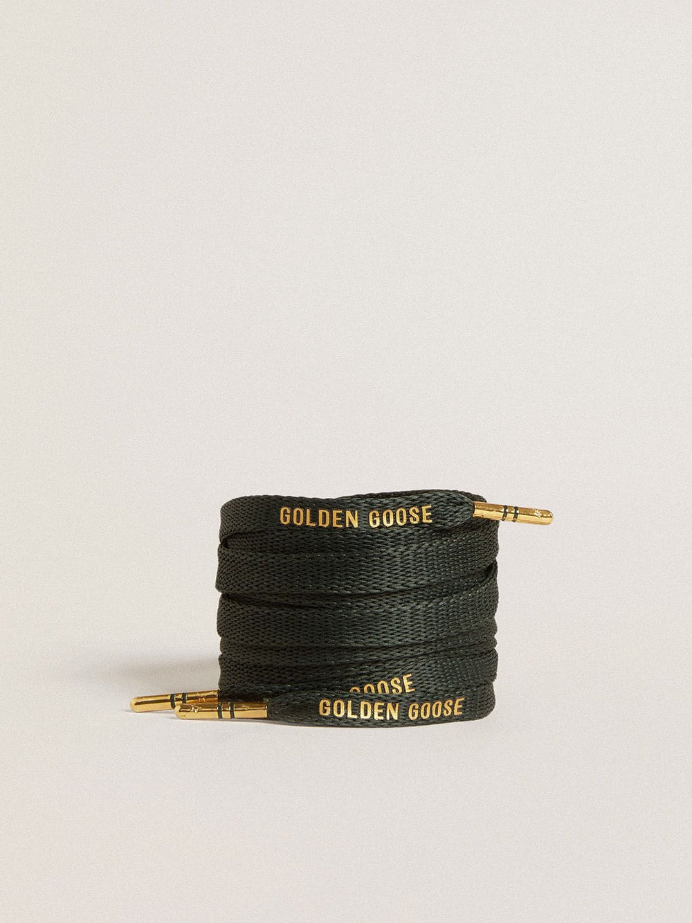 Dark green cotton laces with contrasting gold-colored logo
