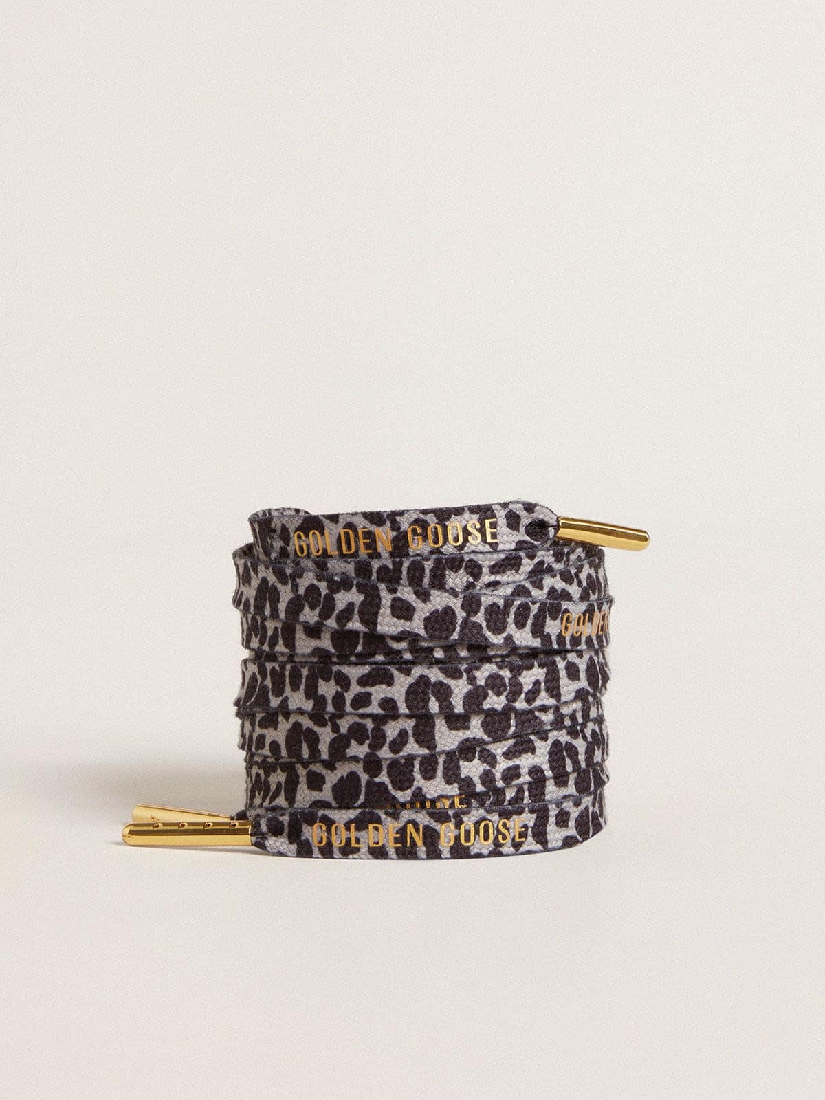 Gray and black animal-print laces with contrasting gold logo