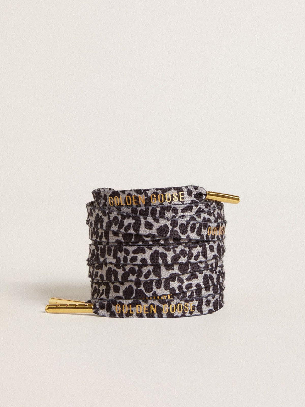 Gray and black animal-print laces with contrasting gold logo