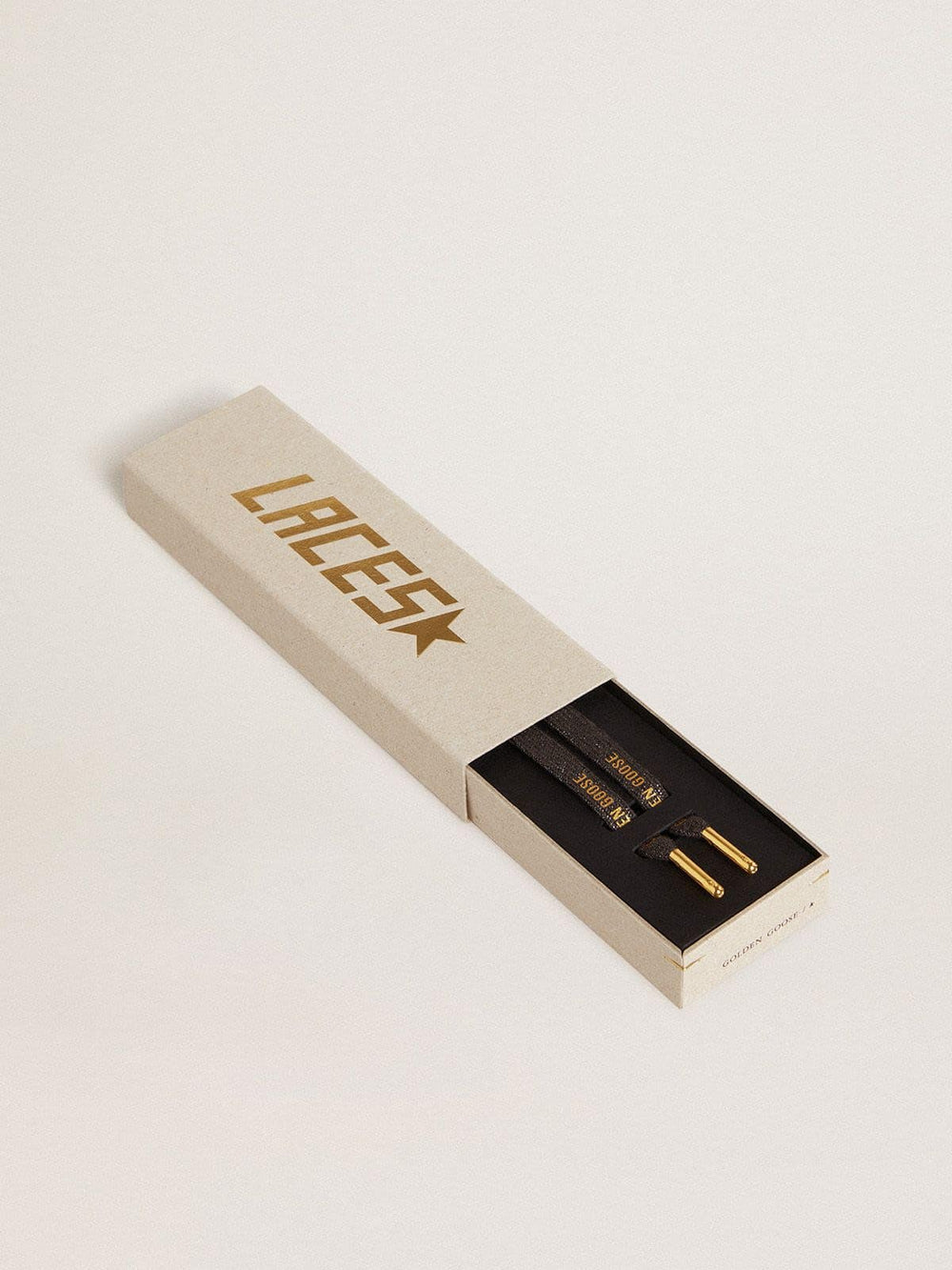 Dark gray lurex laces with contrasting gold logo