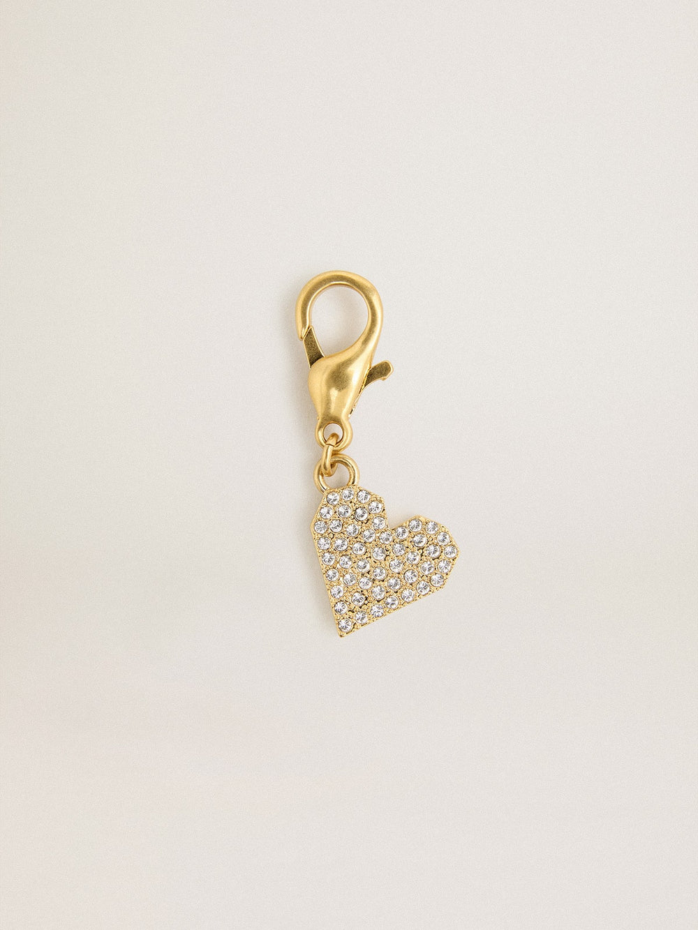 Heart-shaped charm in gold-colored brass with crystals