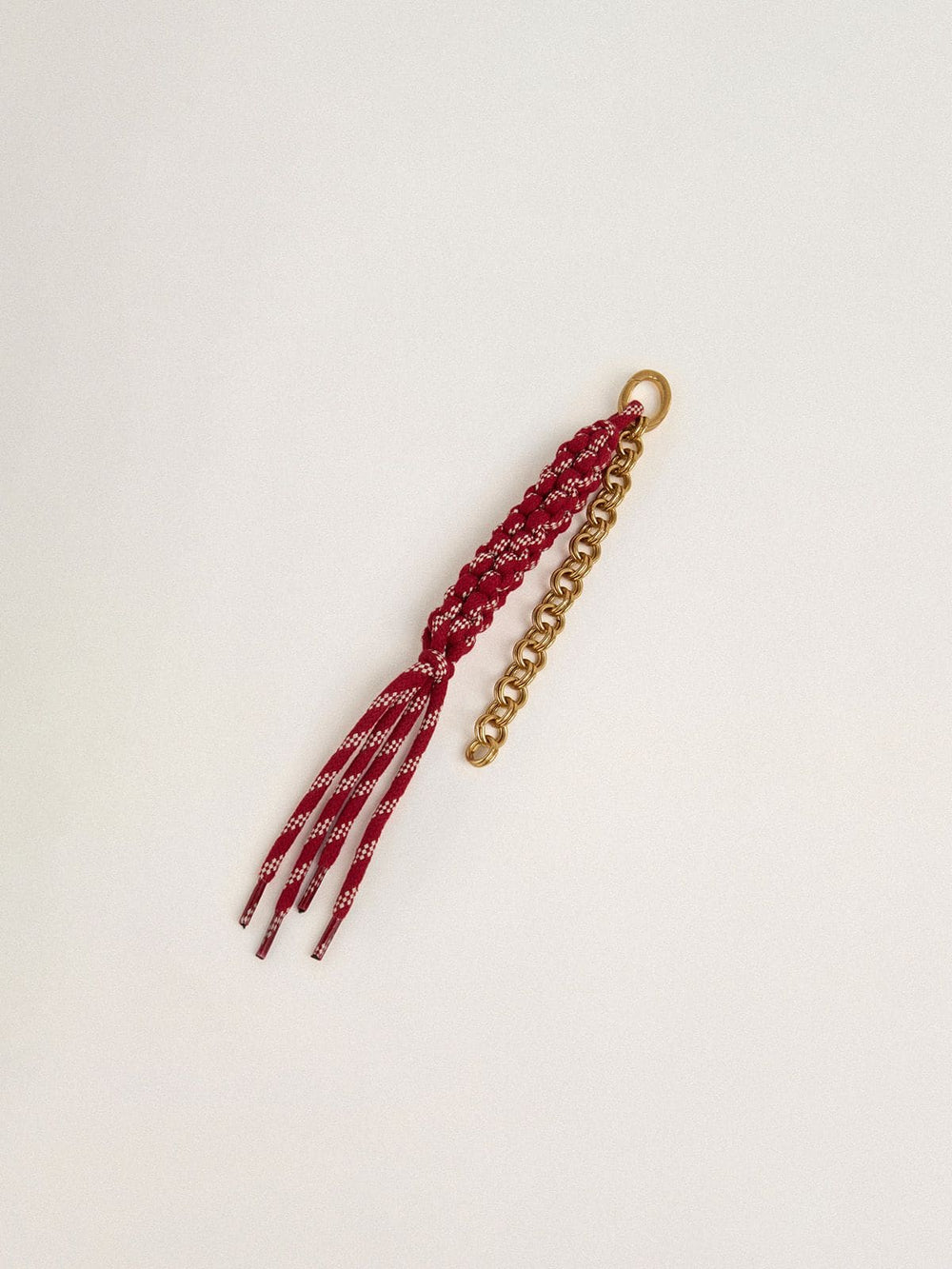 Charm with red knotted laces