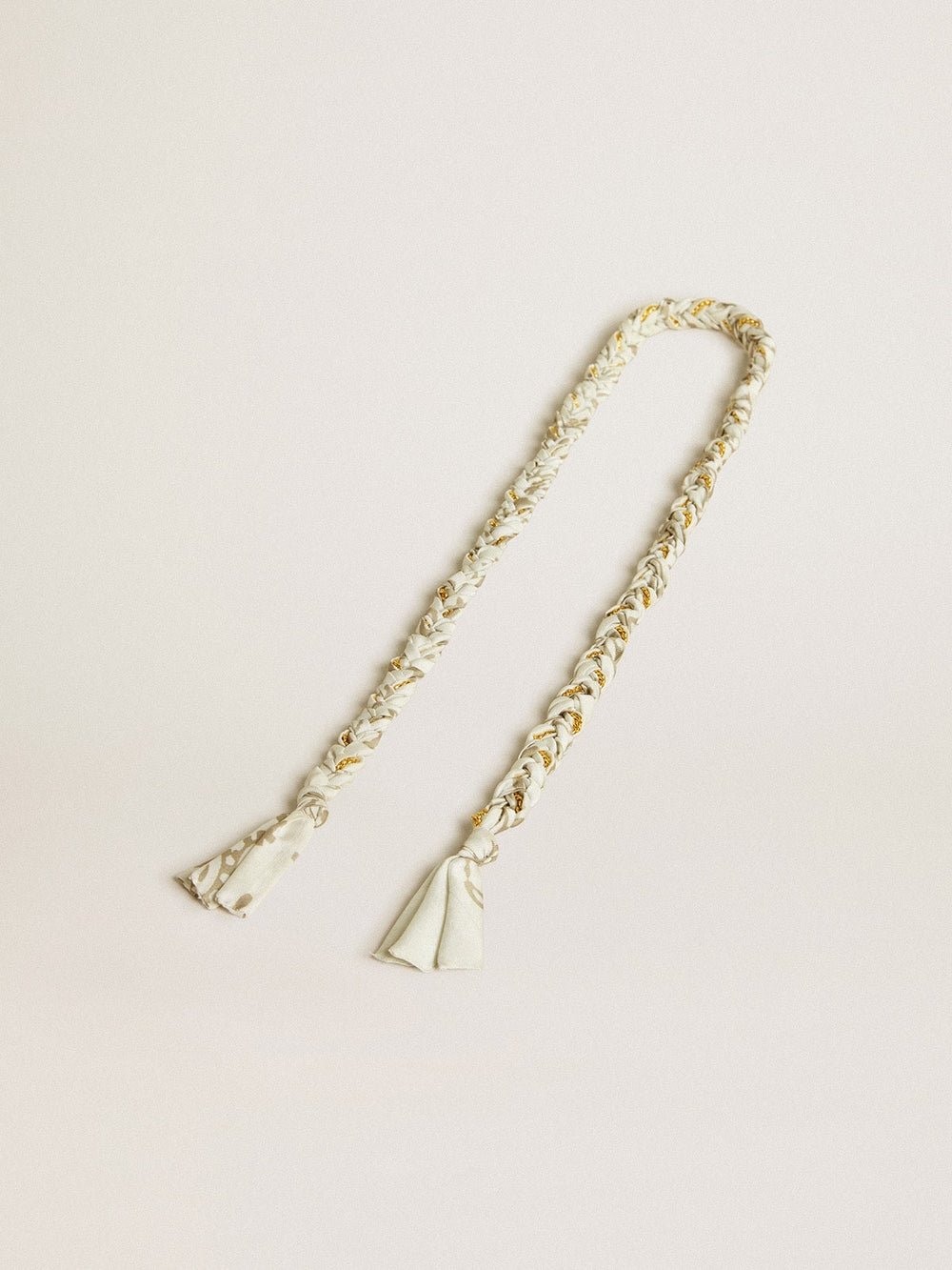 Butter-colored braided fabric charm with brass chain