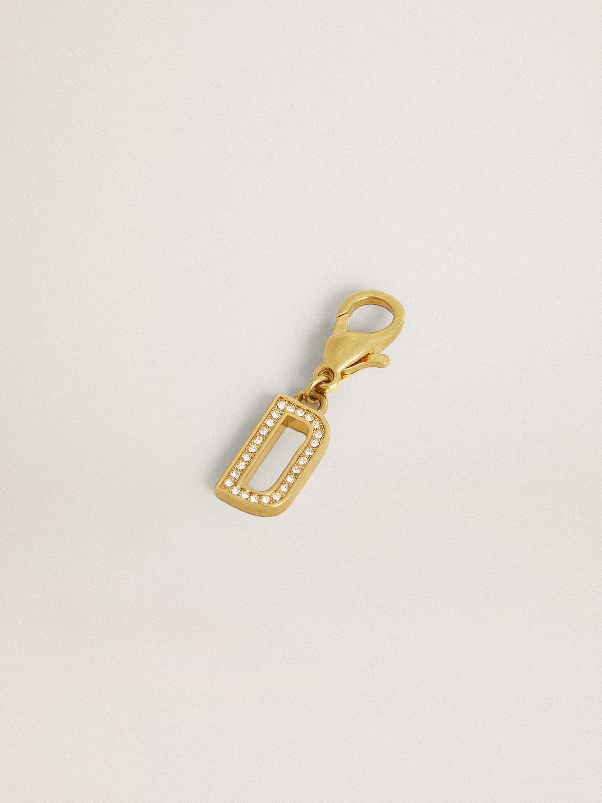 Letter D charm in gold-colored brass with crystals