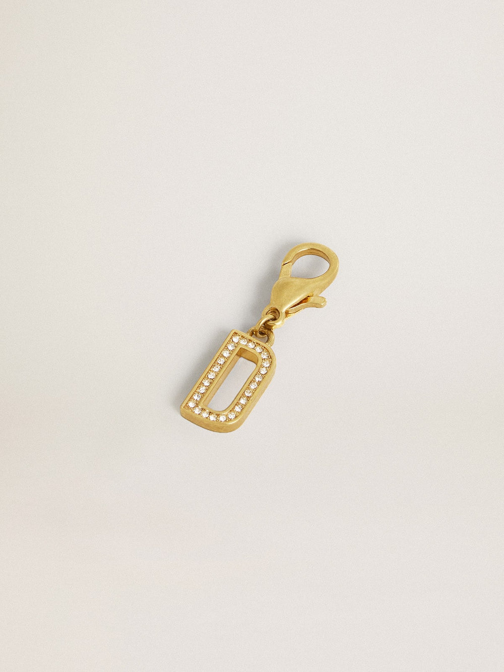Letter D charm in gold-colored brass with crystals