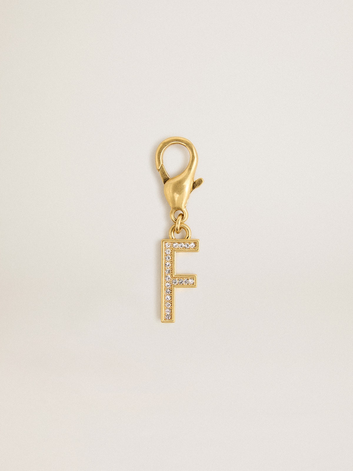 Letter F charm in gold-colored brass with crystals