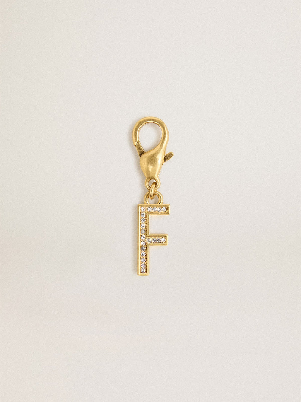 Letter F charm in gold-colored brass with crystals