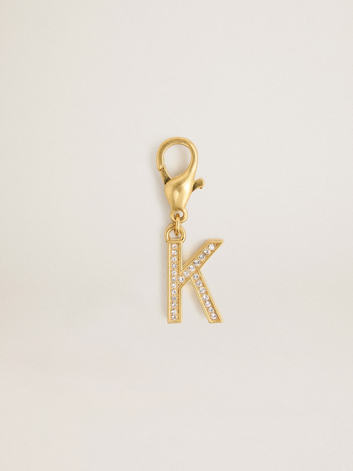 Letter K charm in gold-colored brass with crystals