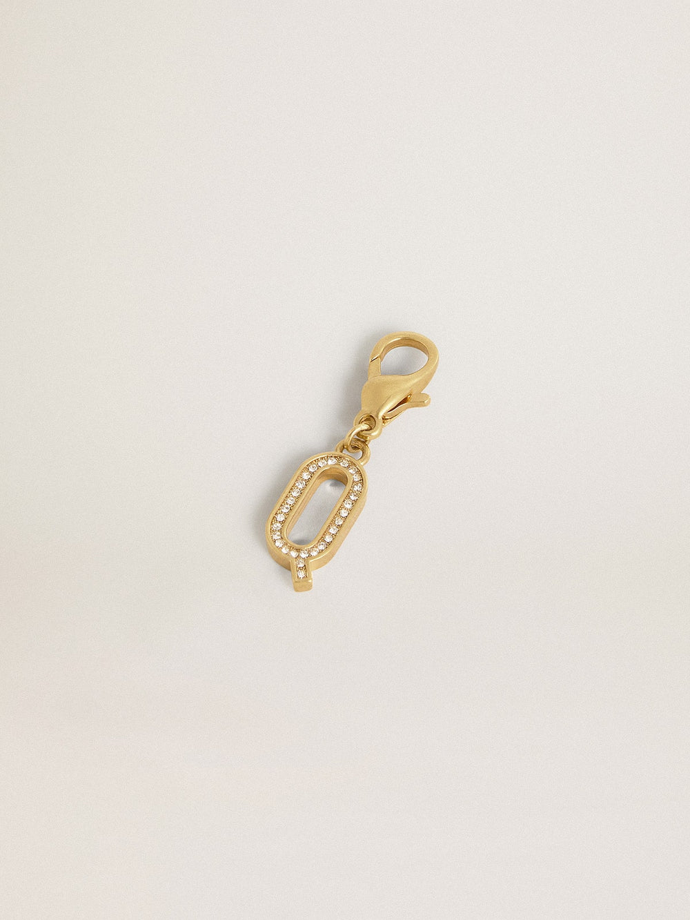 Letter Q charm in gold-colored brass with crystals