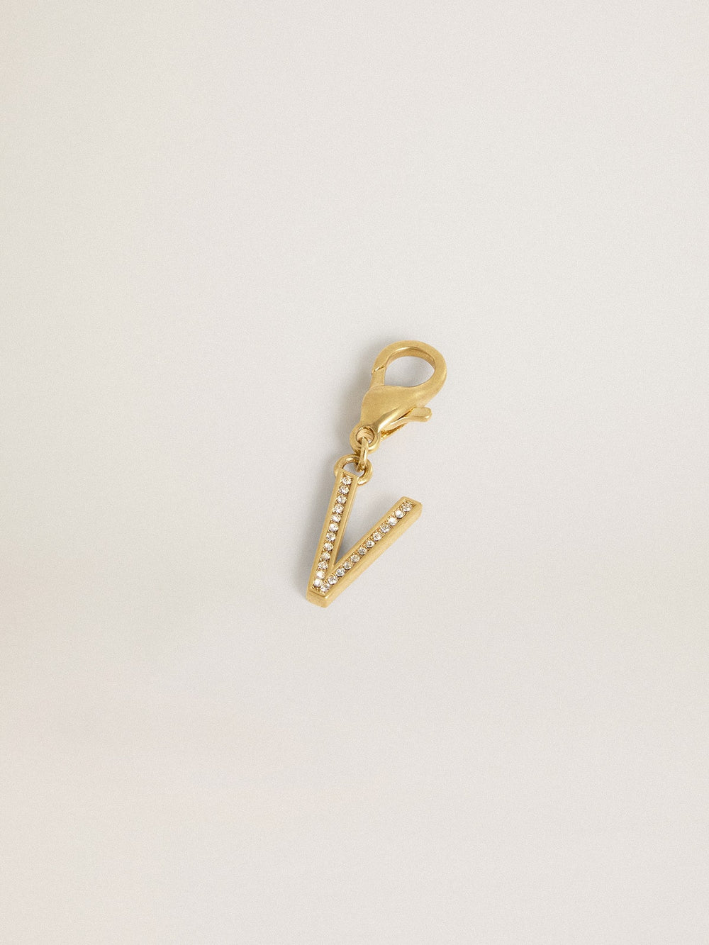 Letter V charm in gold-colored brass with crystals