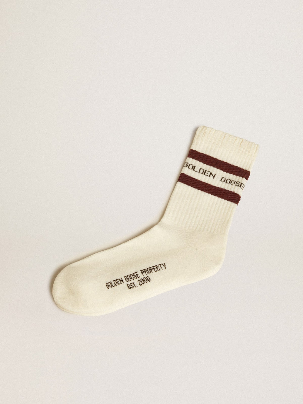 Worn-white socks with distressed details and brown stripes