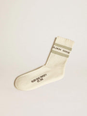 Worn-white socks with distressed details and sage-green stripes