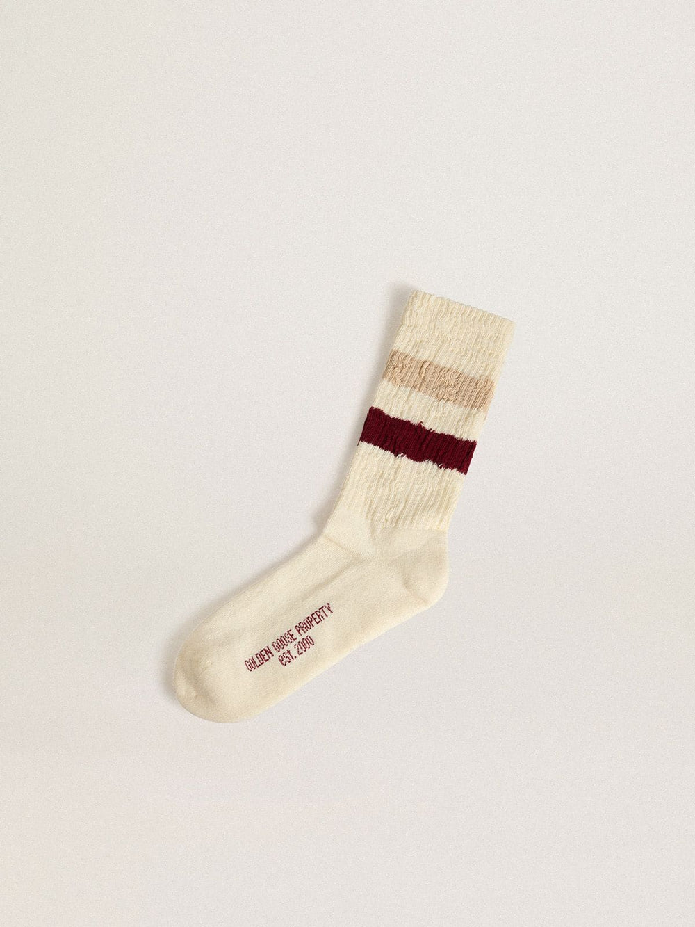 Worn-white socks with distressed details and beige and burgundy stripes