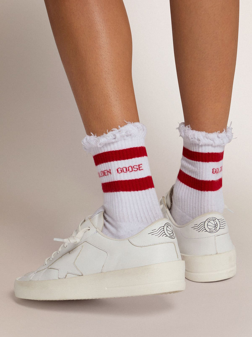 White socks with distressed details and red stripes