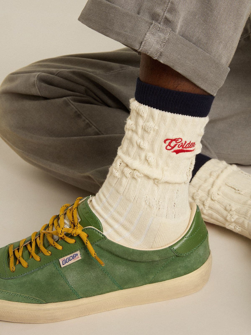 Cream ribbed socks with navy blue details and red logo