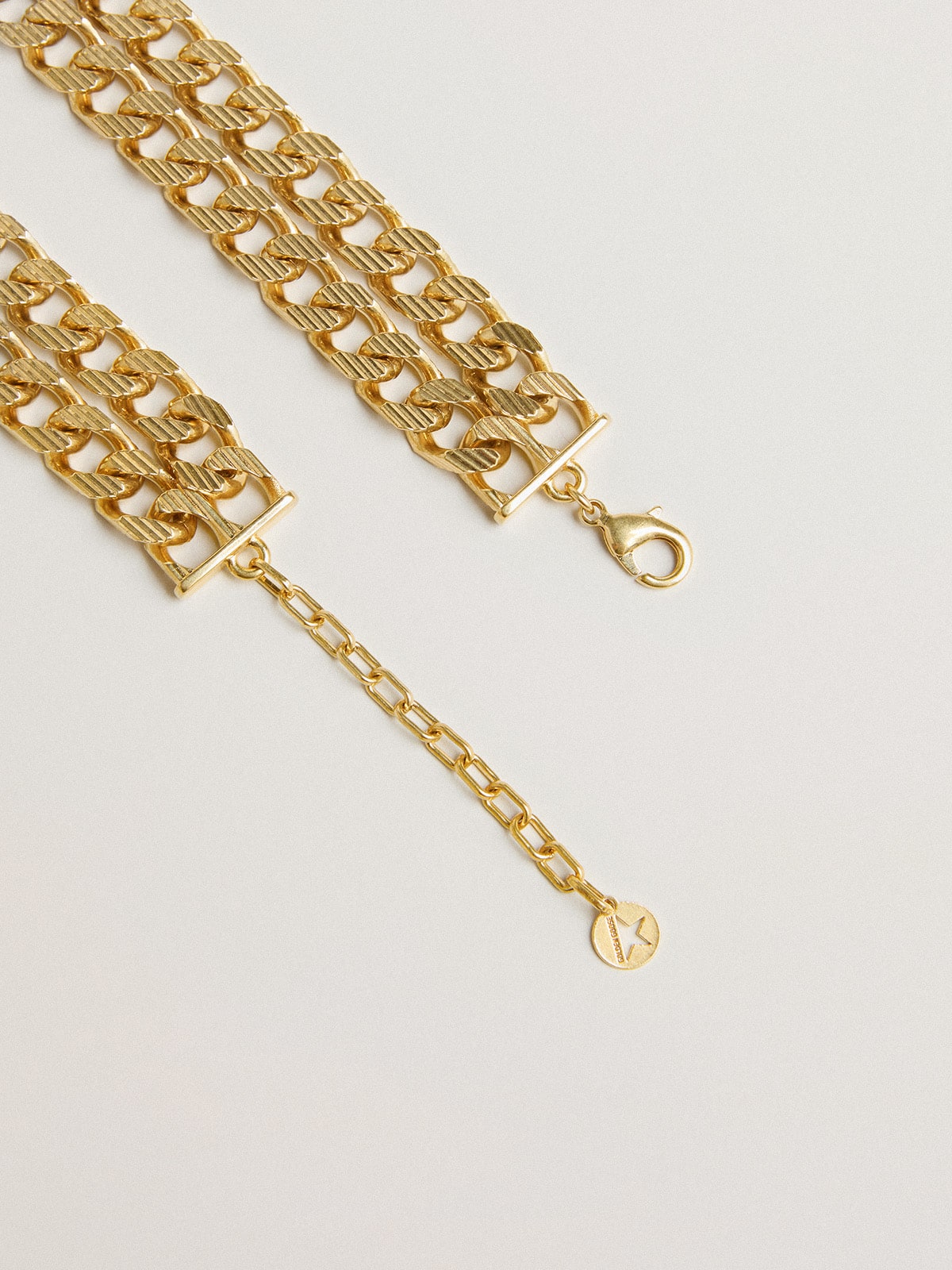 Antique gold-colored braided chain necklace with star-shaped clasp