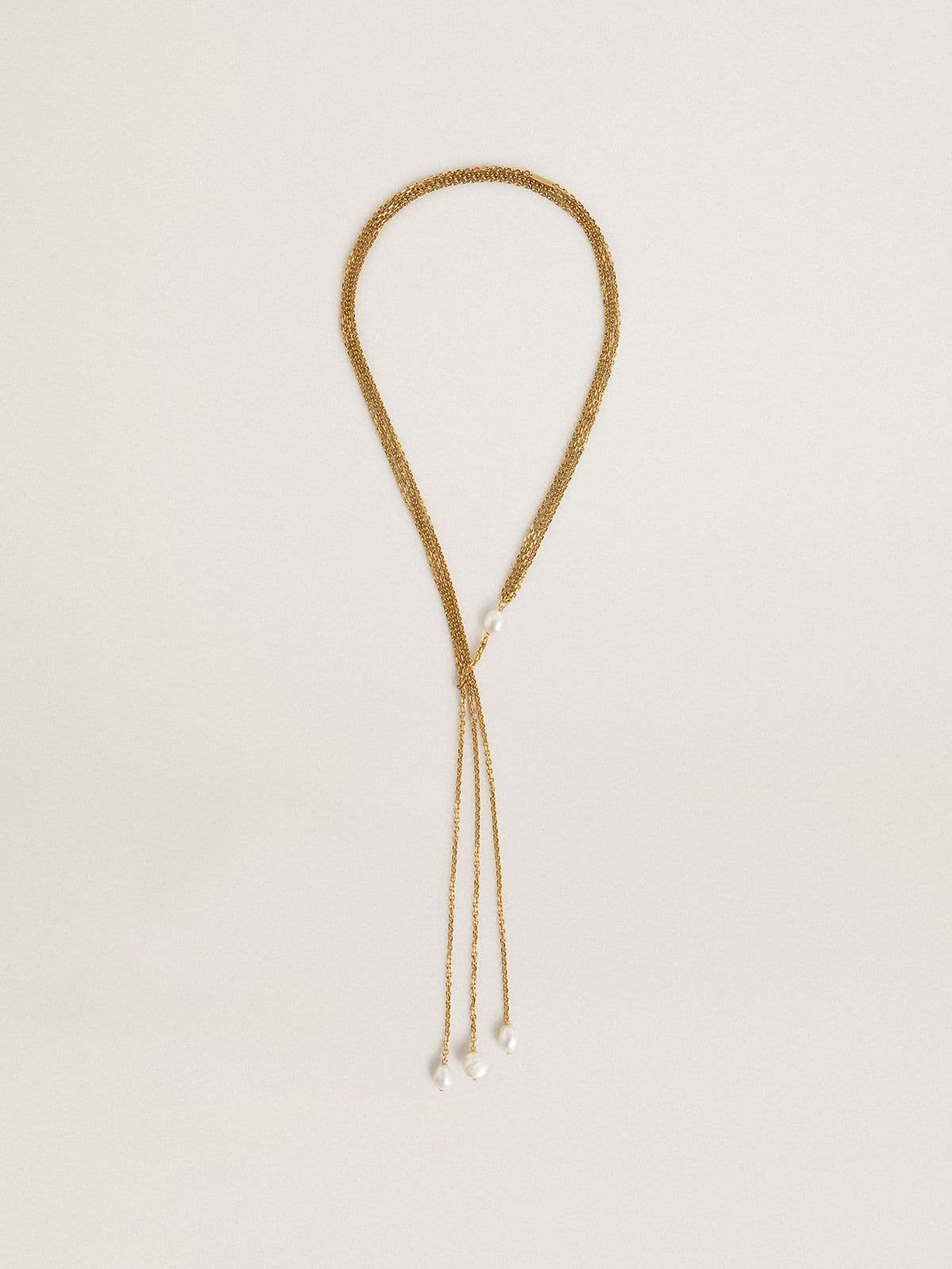 Necklace with antique gold-colored chains with pearls
