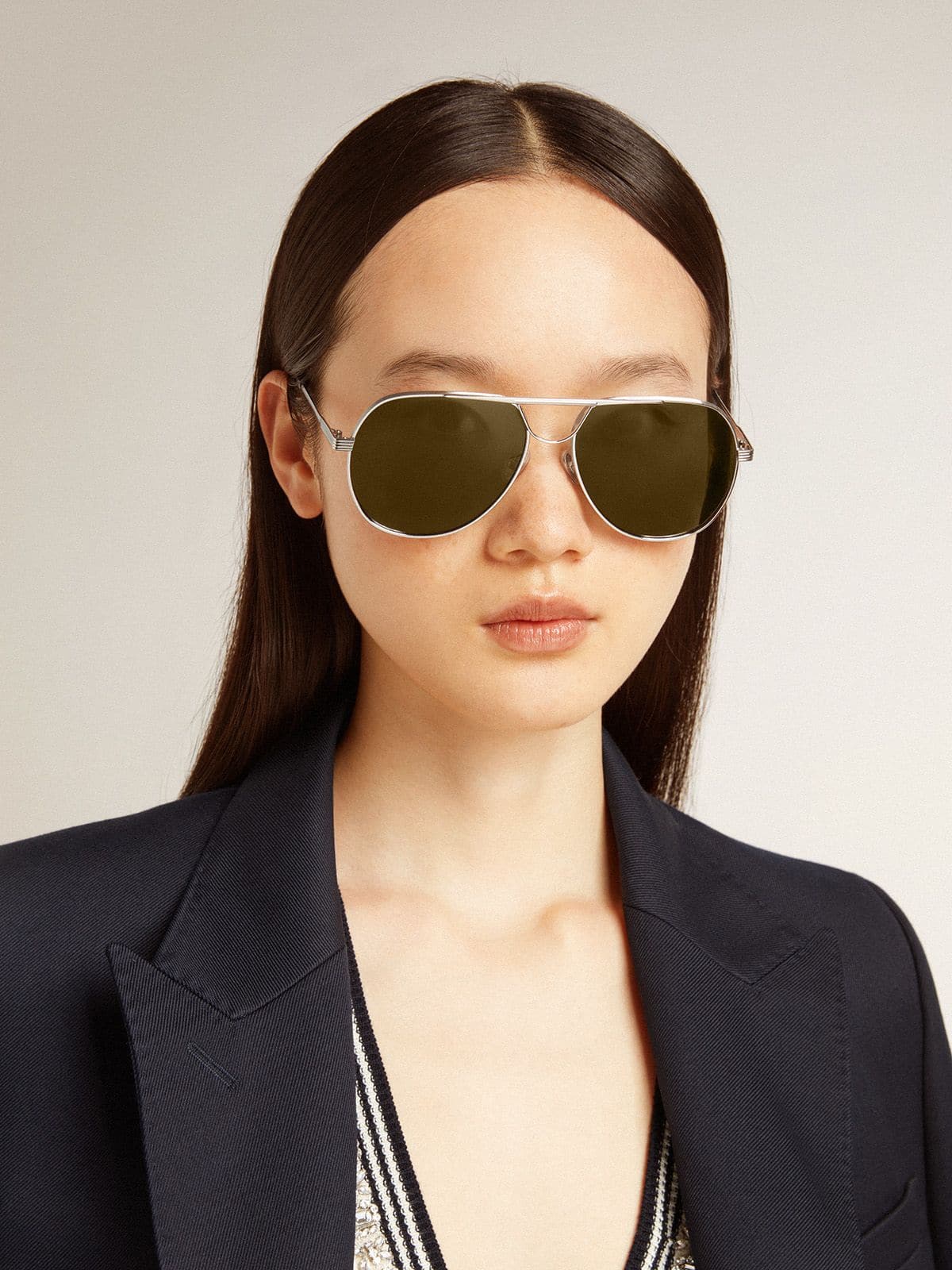 Aviator sunglasses with silver frame and green lenses