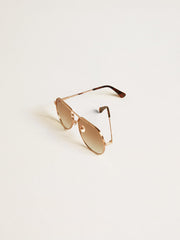 Aviator style sunglasses with rose-gold frame and honey-colored lenses