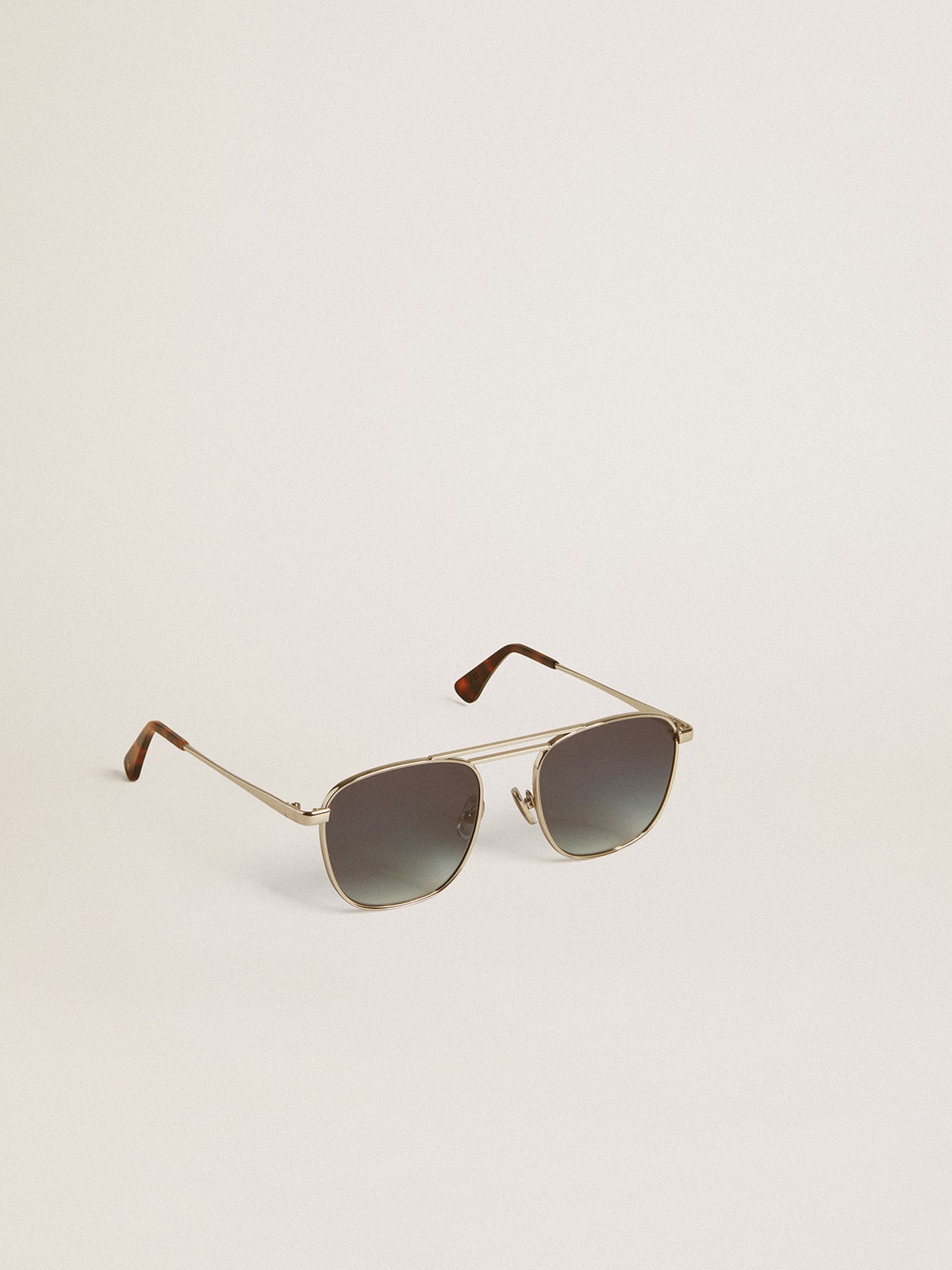 Aviator style sunglasses with silver frame and blue lenses
