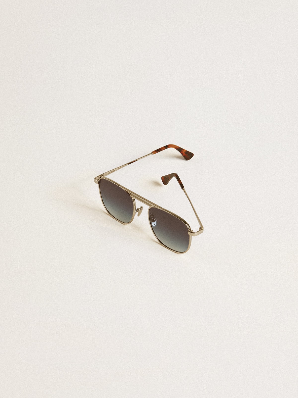 Aviator style sunglasses with silver frame and blue lenses