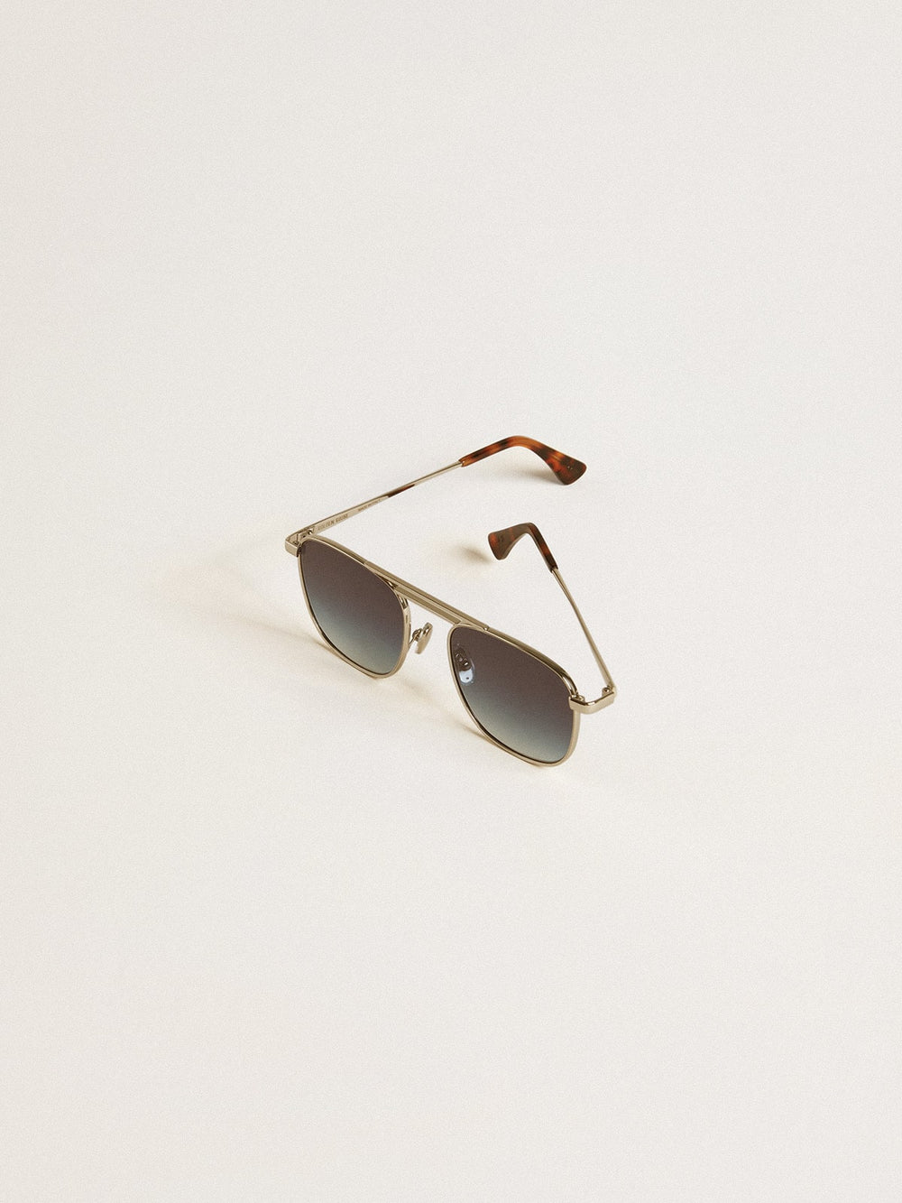 Aviator style sunglasses with silver frame and blue lenses