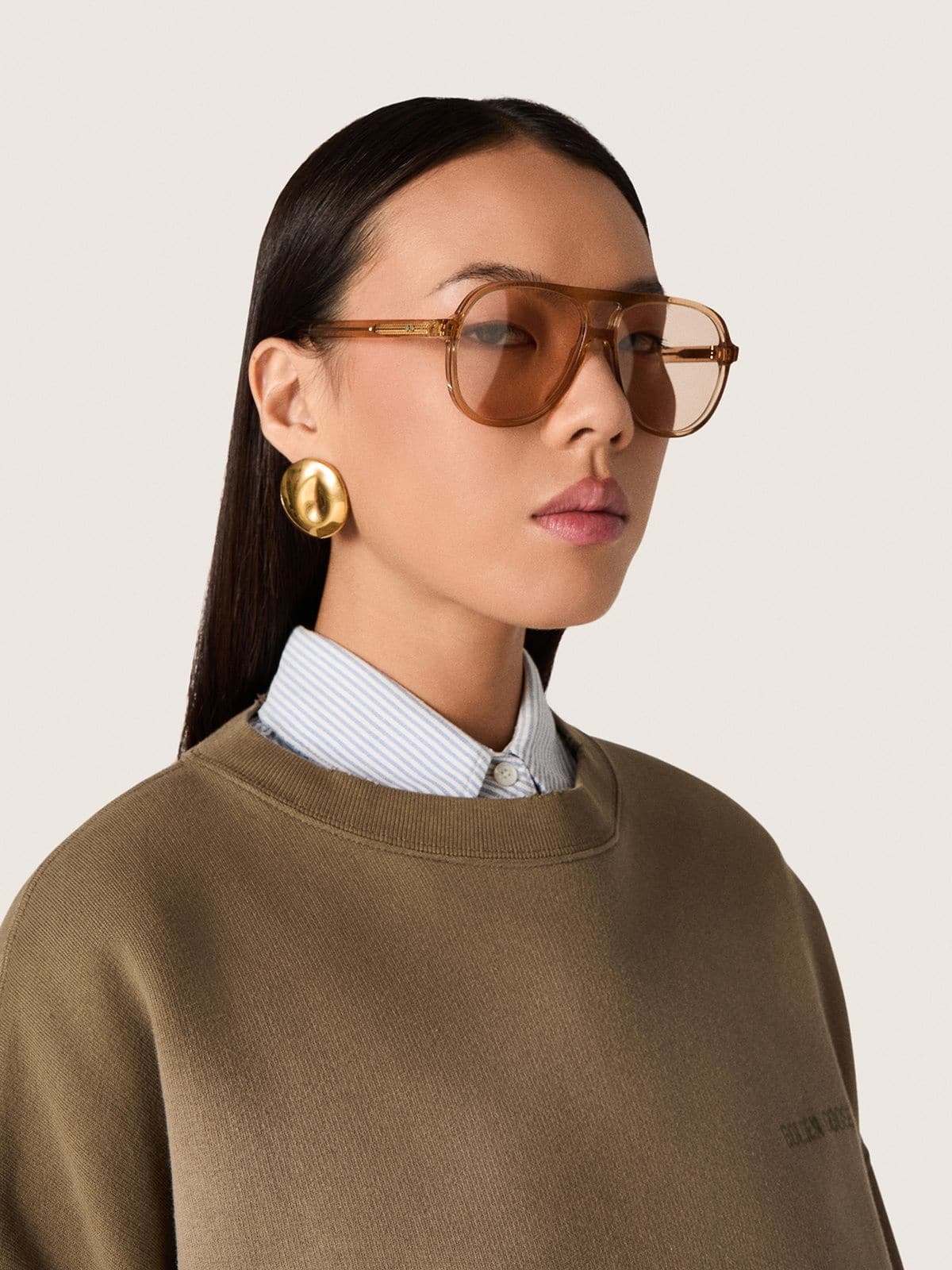 Aviator style sunglasses with honey-colored frame and lenses