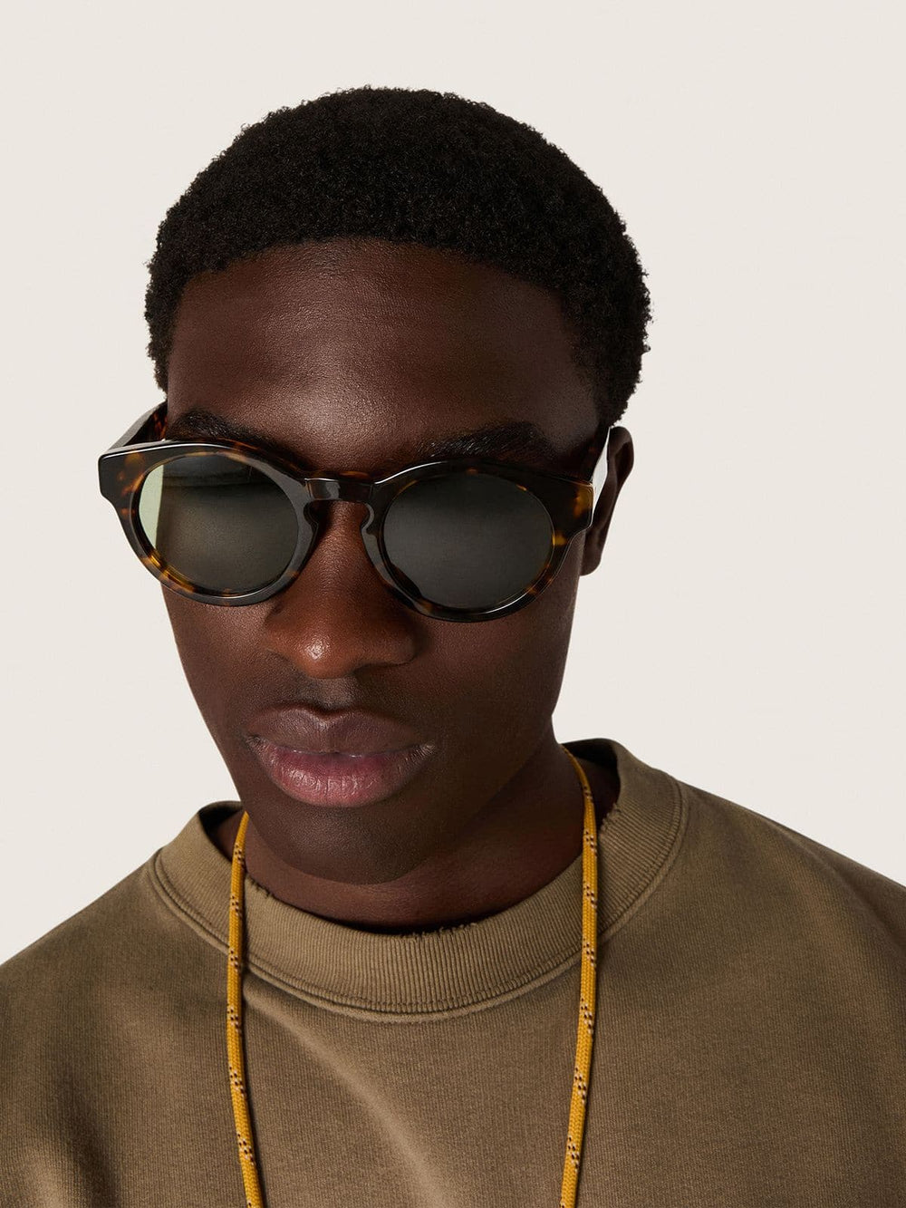 Square style Panthos sunglasses with havana brown frame and green lenses