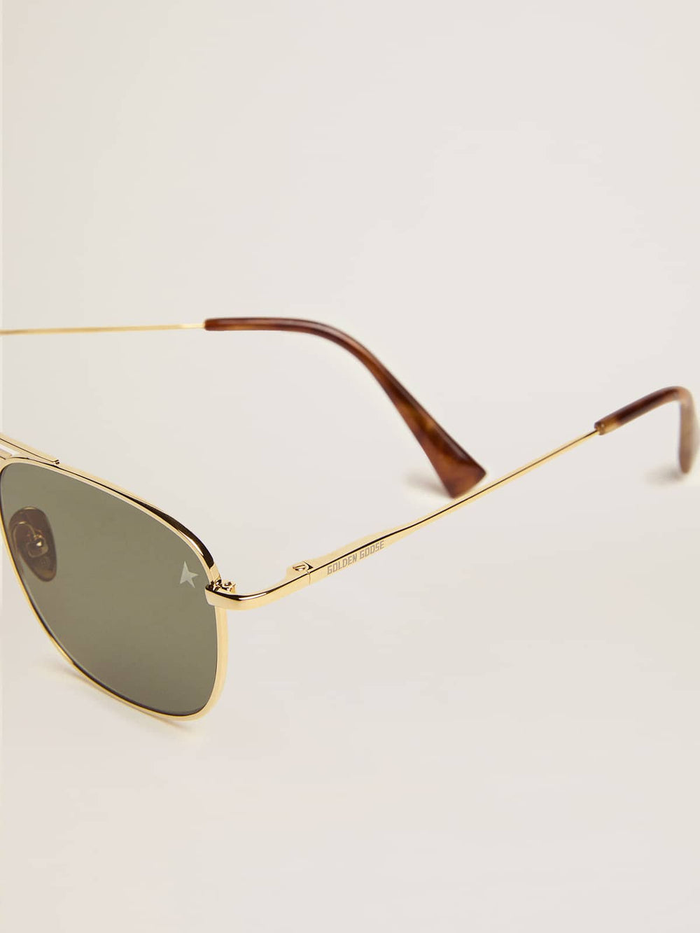 Aviator sunglasses with gold frame and green lenses