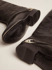 Women's black leather boots with clamp on the heel