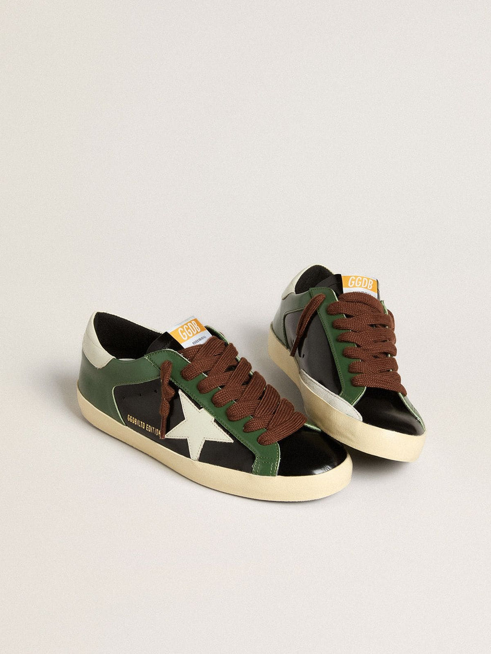 Men’s Super-Star LTD in black laminated leather with white leather star and heel tab