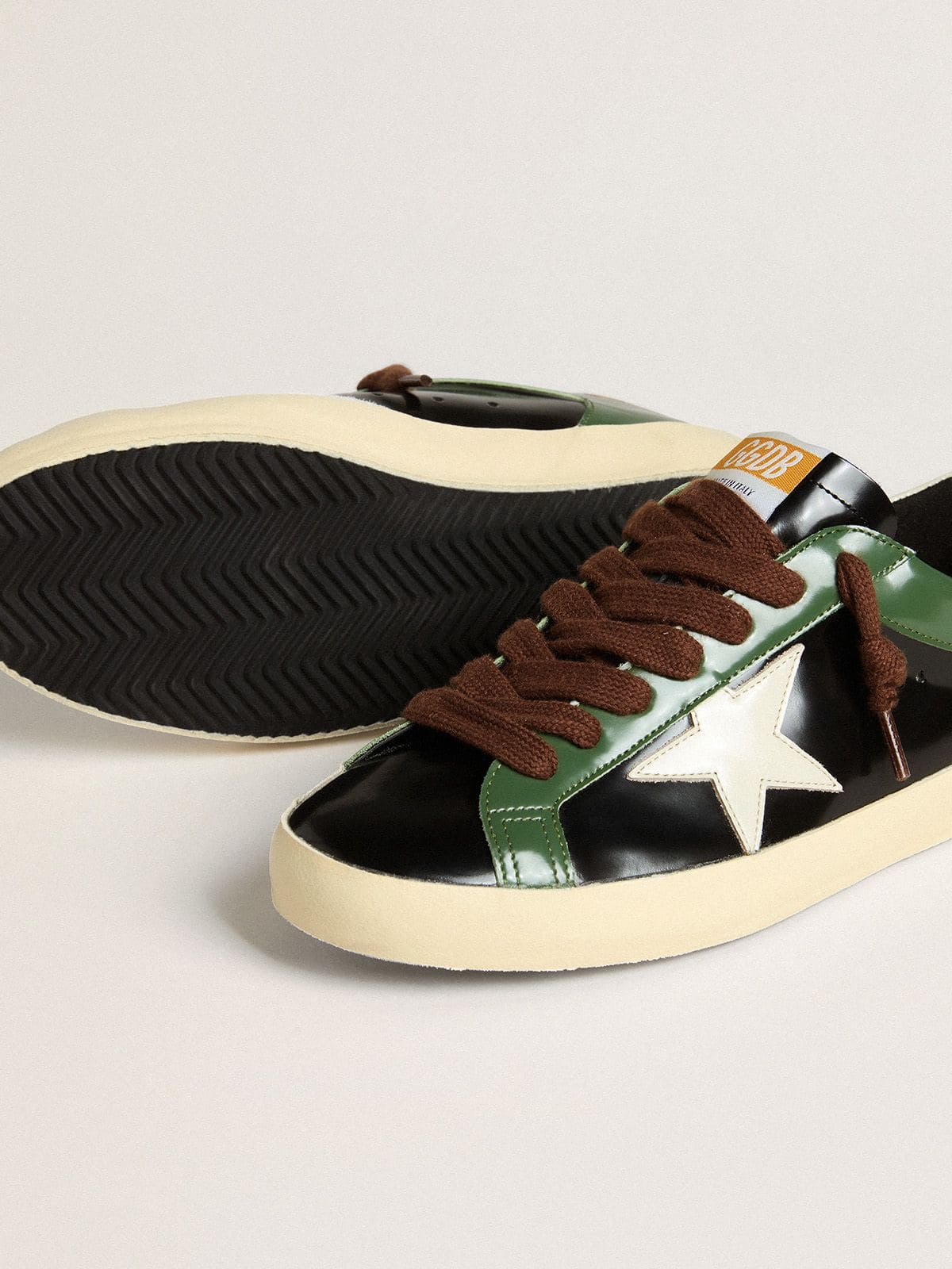 Men’s Super-Star LTD in black laminated leather with white leather star and heel tab