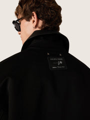 Men's short padded jacket in black cotton with leather collar