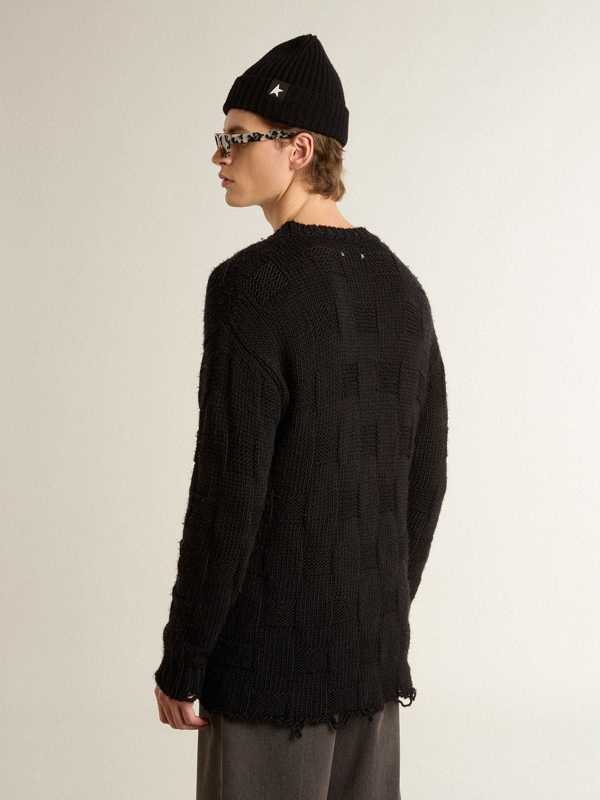 Men's black wool sweater with a distressed effect