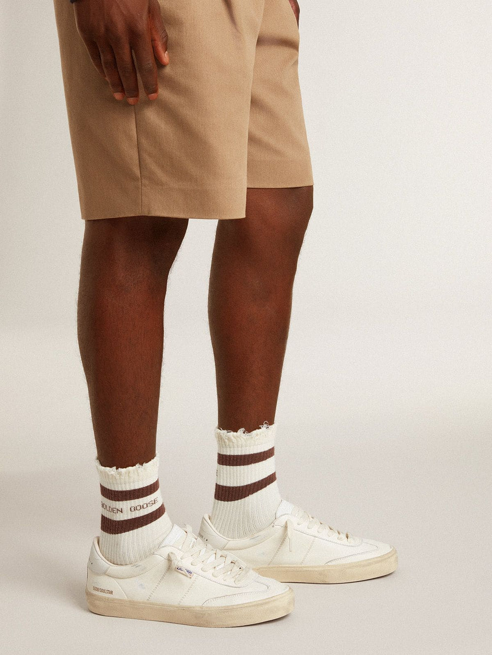 Men's white cotton cardigan with a cable pattern and blue ribbing