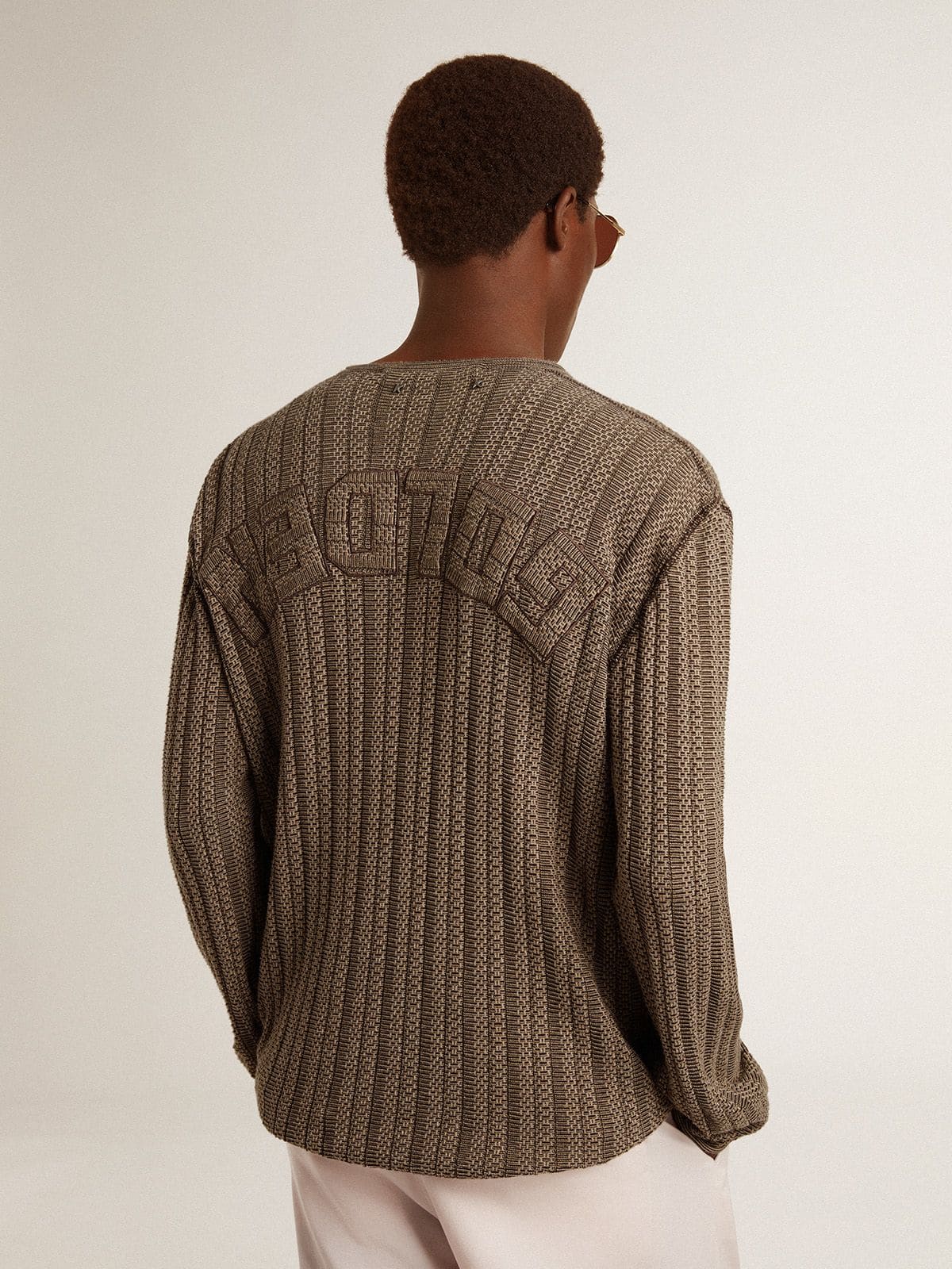 Men's travertine-colored sweater with 'Golden' patch lettering on the back