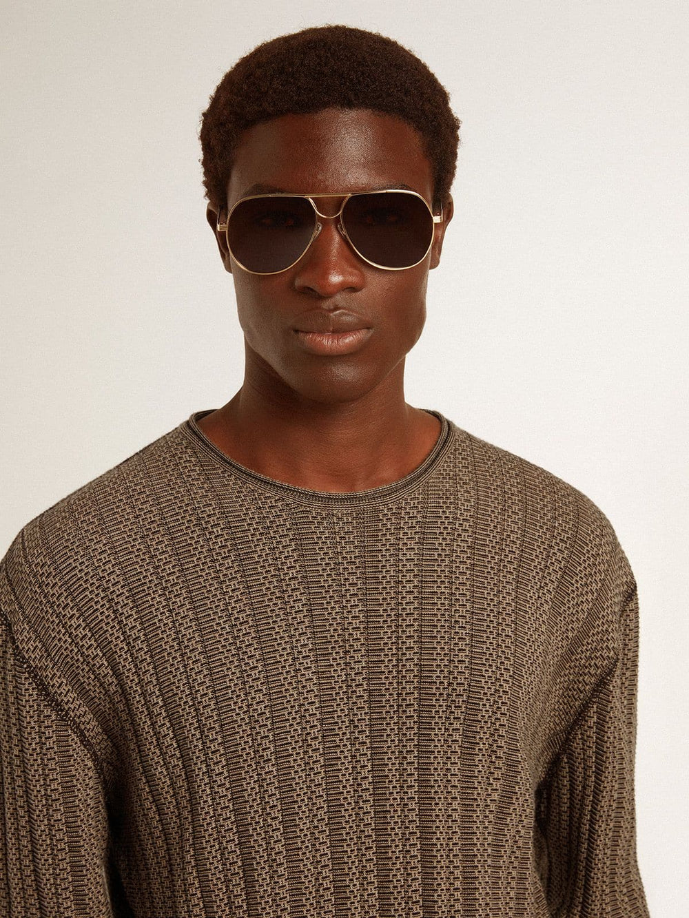 Men's travertine-colored sweater with 'Golden' patch lettering on the back
