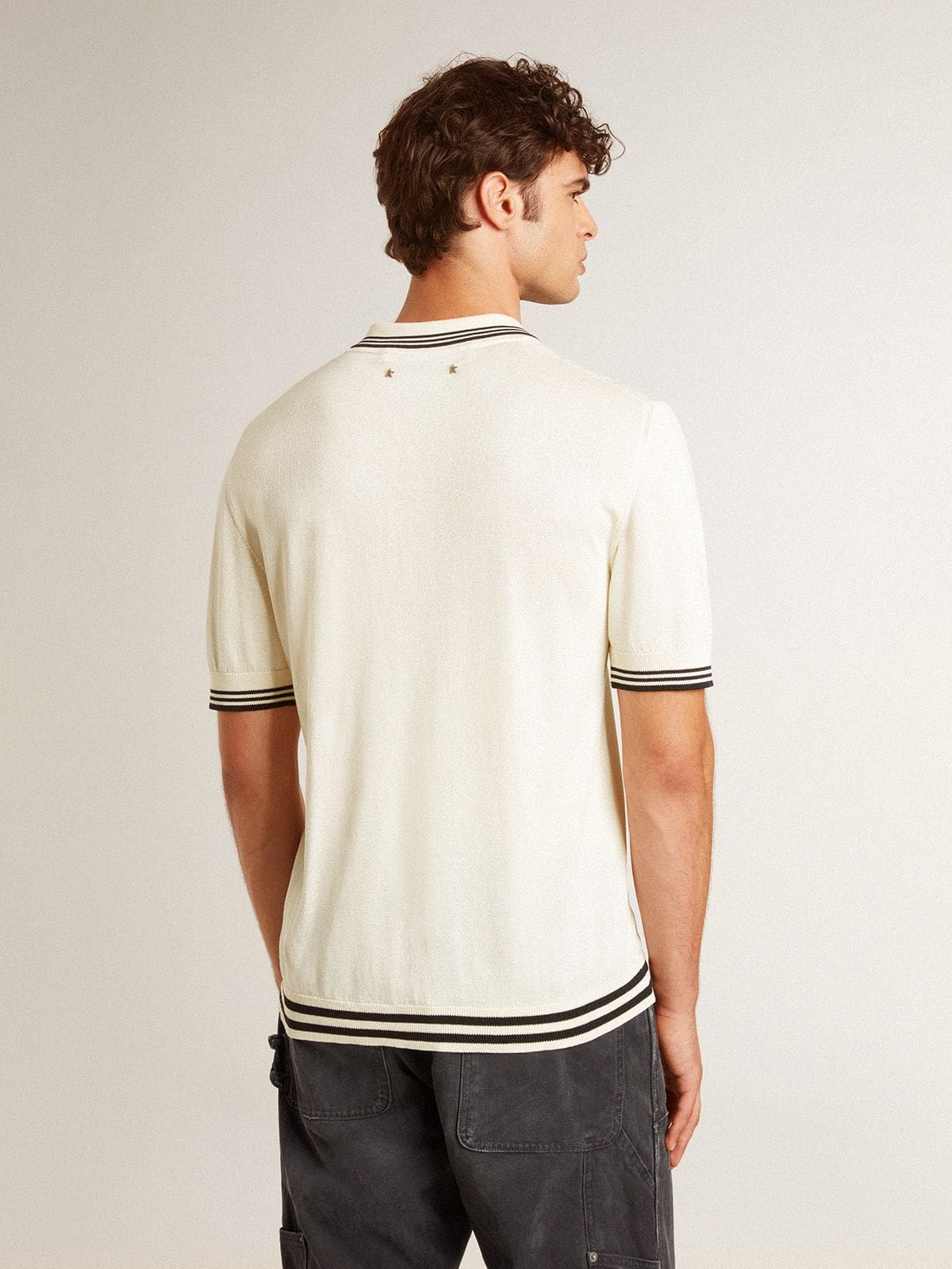 Men's worn-white knitted polo shirt with blue ribbing